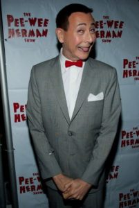 Paul Reubens posing in front of The Pee-wee Herman show’s flex