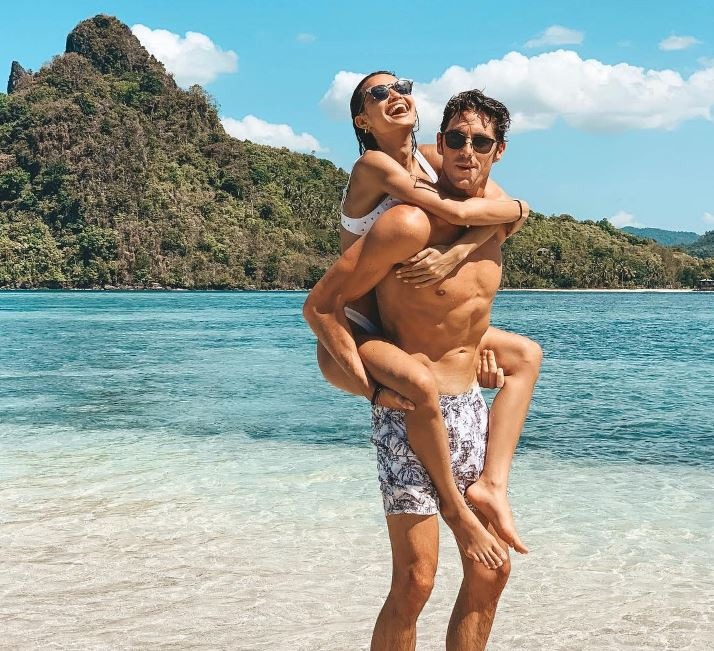 Kelsey Merritt with her boyfriend, Conor Dwyer, playing on a beach