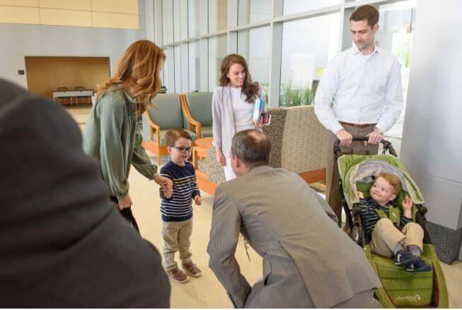 Daniel Mark Cotton is smiling in a baby carrier on the left side during a visit to UAMS. Source: UAMS News