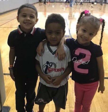 Zayden Banks with his siblings Angelo Banks and Bella Banks in a basketball arena. Source: Pinterest