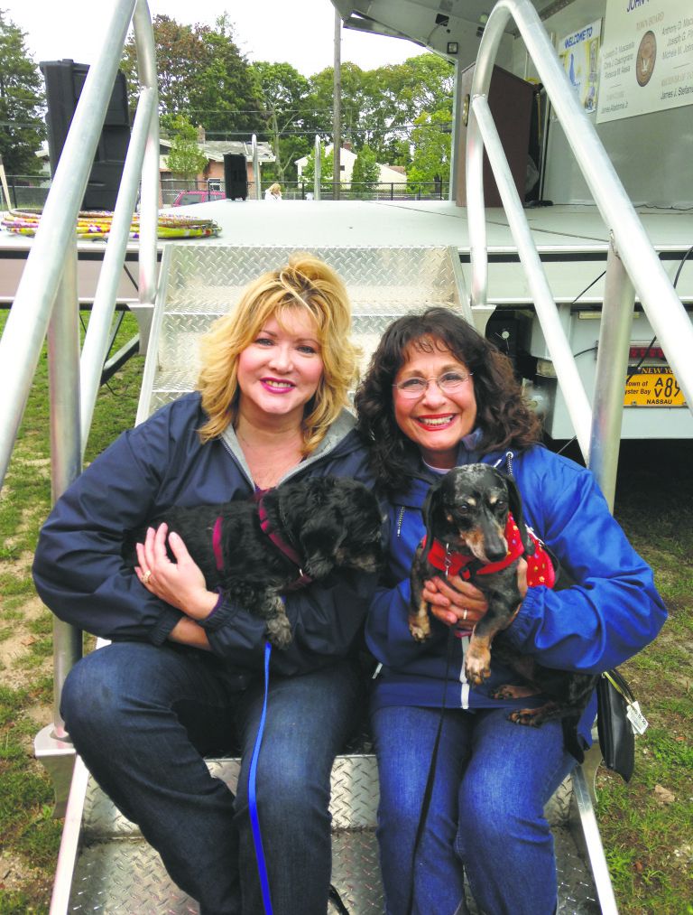 Lea Tyrrell sitting on the ladder carrying puppy with her friends (Photo: Massapequa Observer)